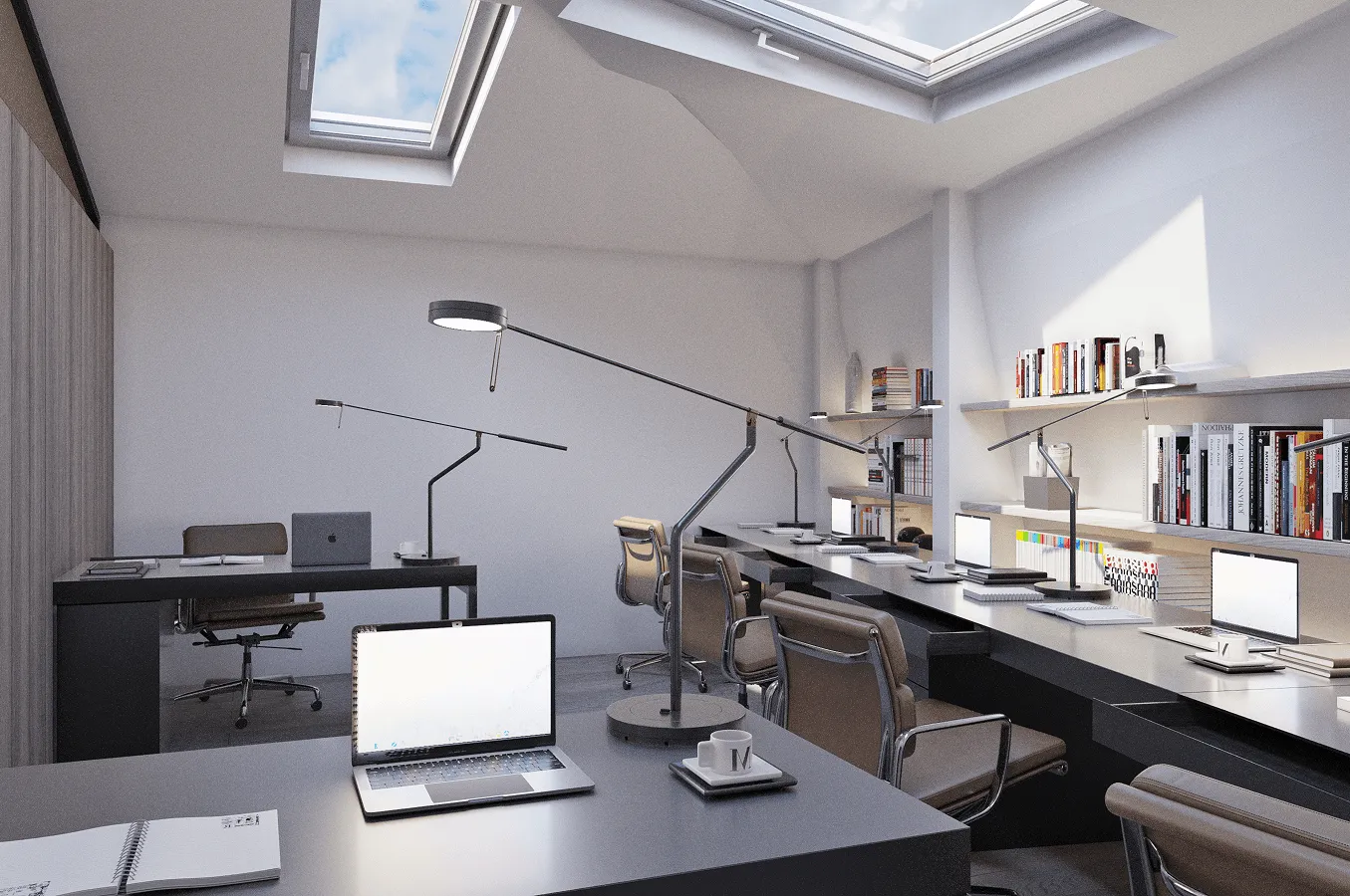 Workspace with desks beneath roof-level skylights and open shelving