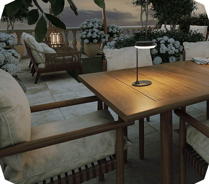 Cozy outdoor terrace at dusk with table lamp and flowers